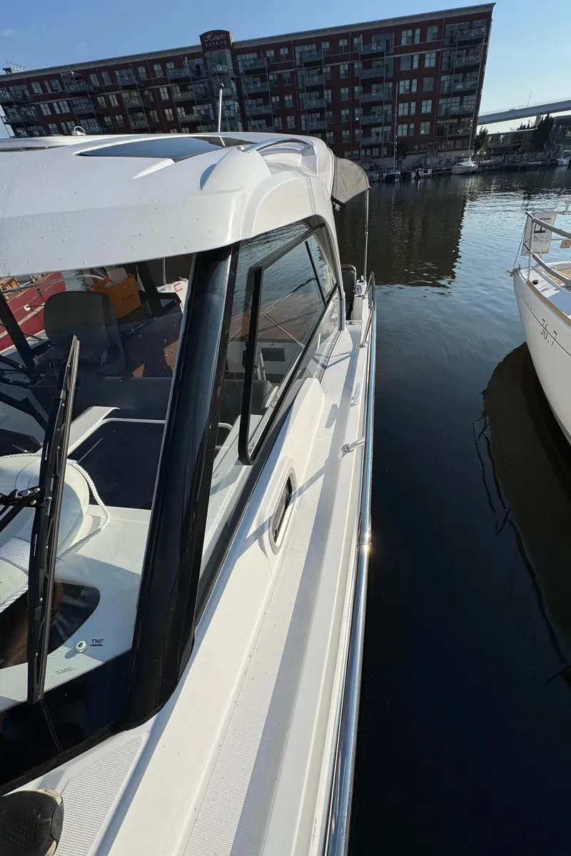 Slide: The Image of 2023 Beneteau Antares 9 docked at marina, modern design, waterfront view. - 3