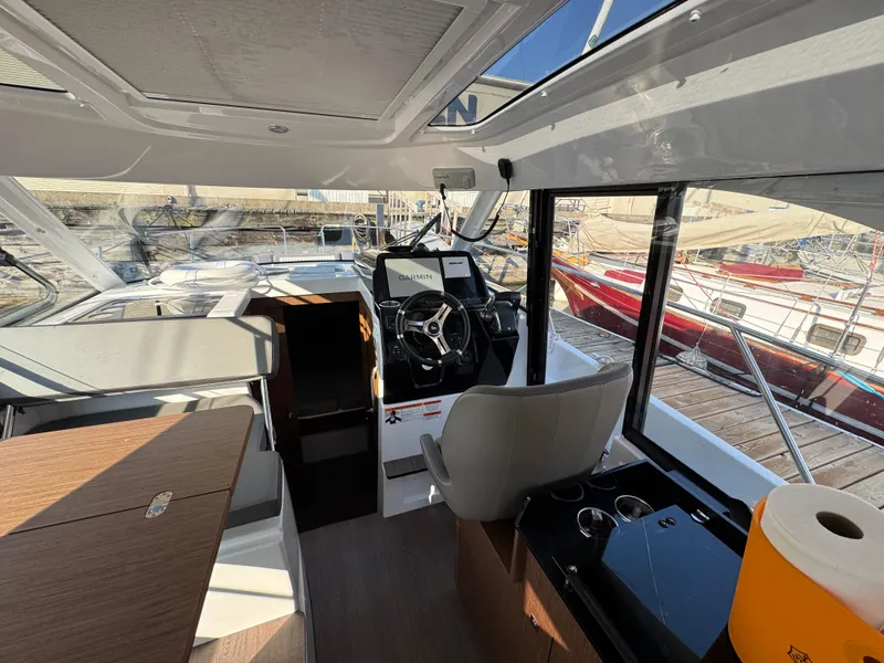 Slide: The Image of Interior of 2023 Beneteau Antares 9 boat, featuring helm and seating area. - 33