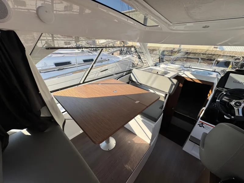 Slide: The Image of Interior of 2023 Beneteau Antares 9 boat with seating and table. - 35