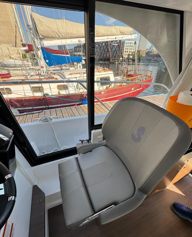 Slide: The Image of Interior of 2023 Beneteau Antares 9 with harbor view through window. - 38