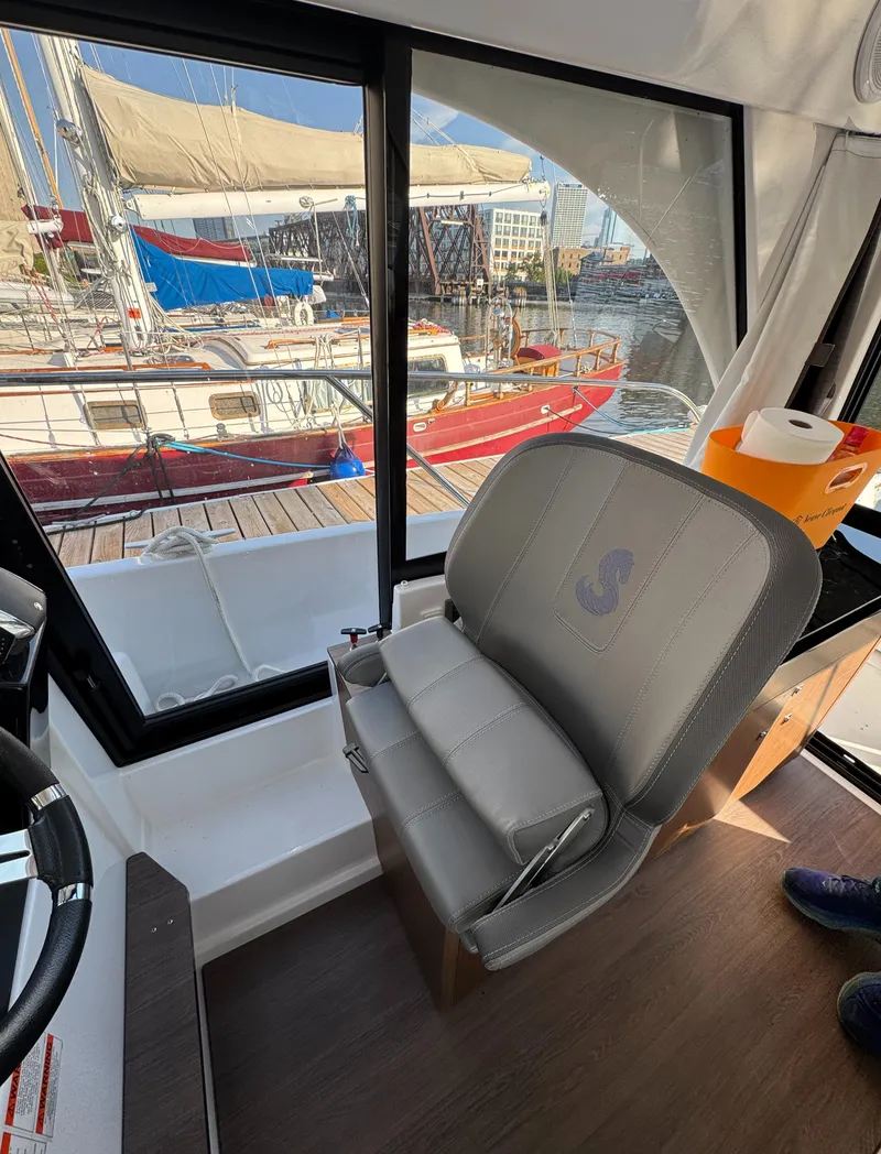 Slide: The Image of Interior view of 2023 Beneteau Antares 9 boat with harbor background. - 39