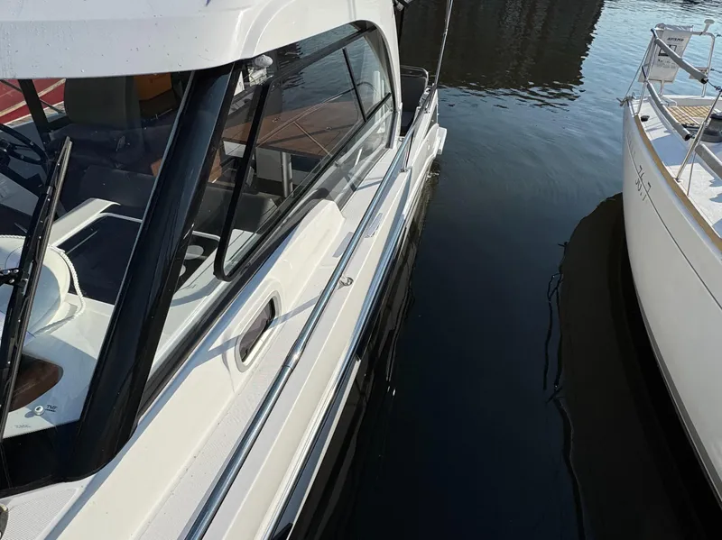 Slide: The Image of 2023 Beneteau Antares 9 boat docked on calm water. - 4