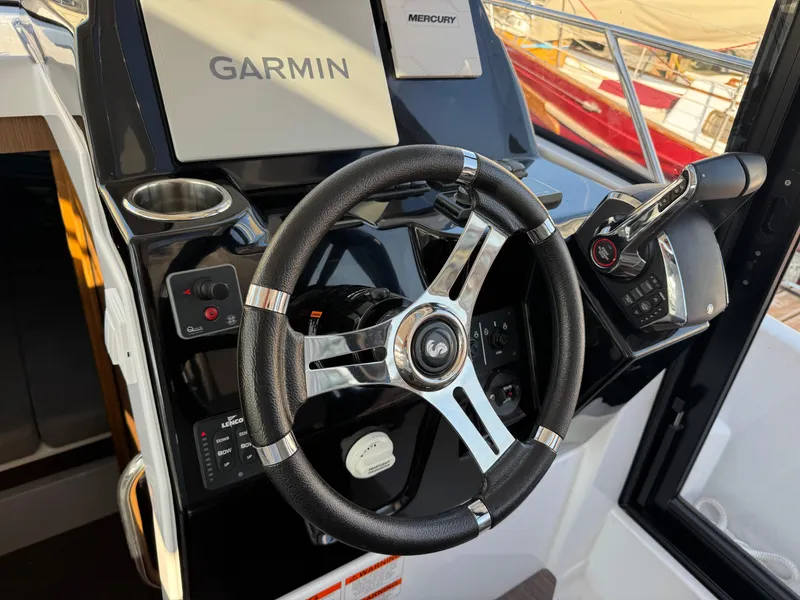 Slide: The Image of Steering wheel and controls of 2023 Beneteau Antares 9 boat with Garmin system. - 40