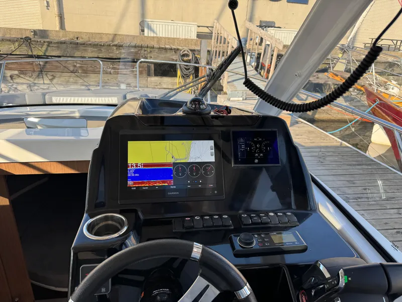 Slide: The Image of 2023 Beneteau Antares 9 helm with navigation display and controls. - 42