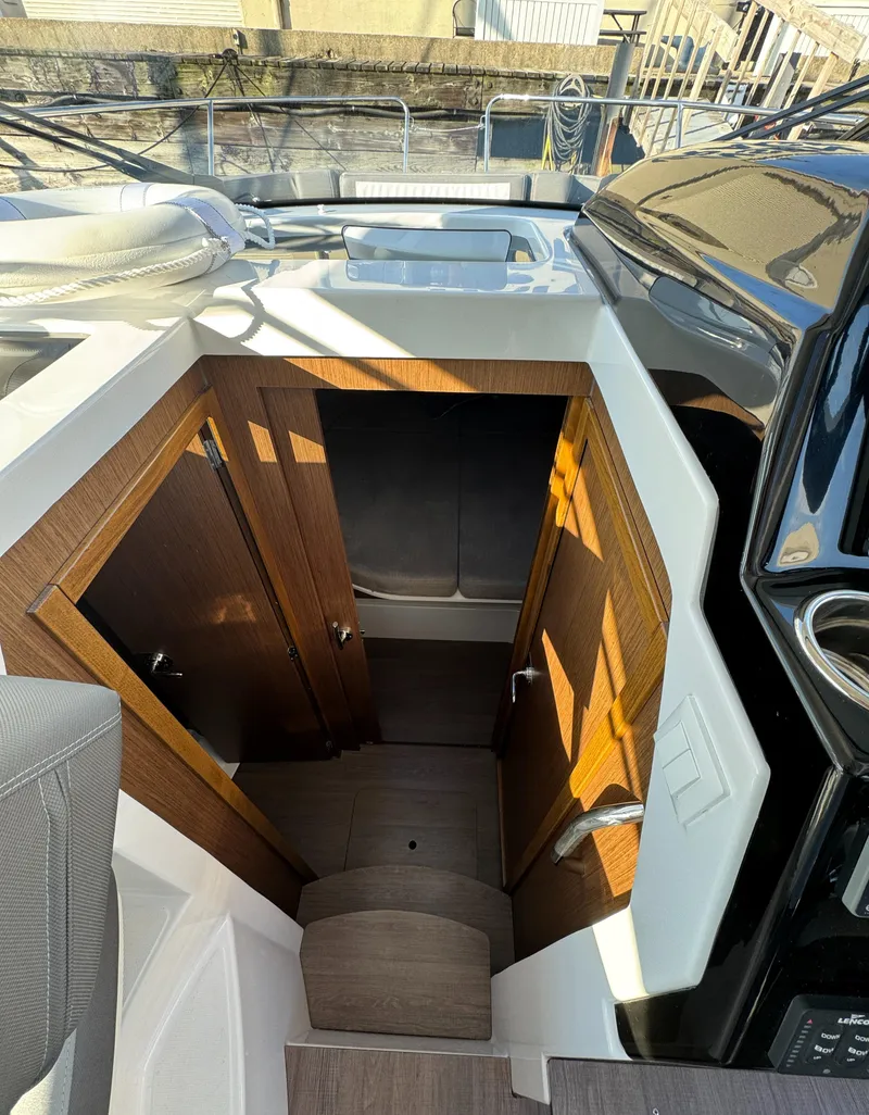 Slide: The Image of Interior view of 2023 Beneteau Antares 9 boat, featuring wooden cabin stairs. - 45