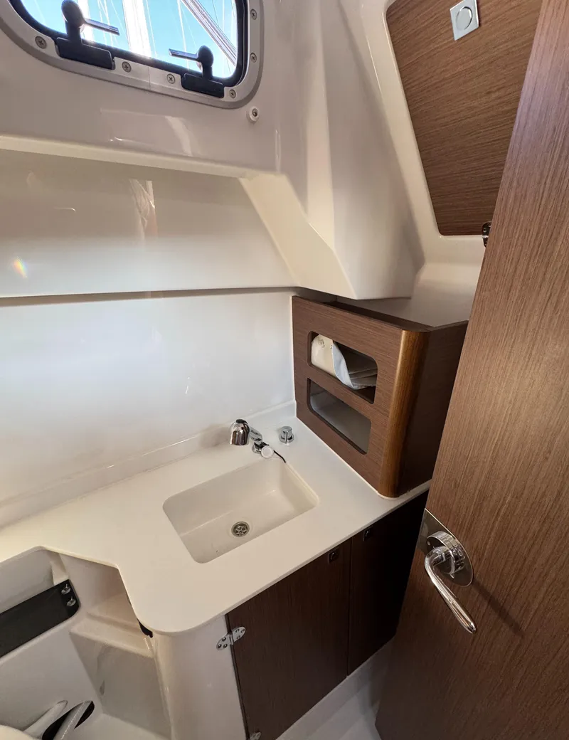 Slide: The Image of 2023 Beneteau Antares 9 bathroom with modern sink and wooden cabinetry. - 47