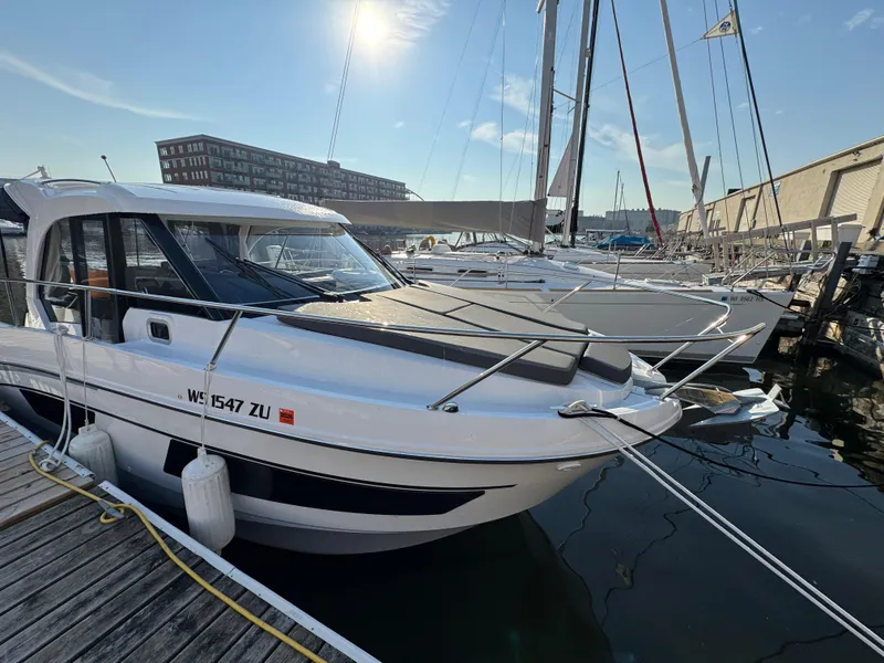Slide: The Image of 2023 Beneteau Antares 9 docked at marina under sunny sky. - 9