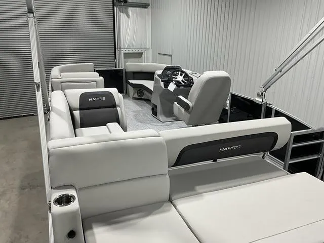 Slide: The Image of 2025 Harris Cruiser 210 SL pontoon boat interior with plush seating and modern helm. - 11