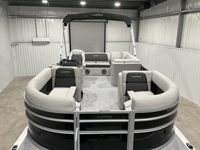 Slide: The Image of 2025 Harris Cruiser 210 SL pontoon boat in a storage facility. - 6