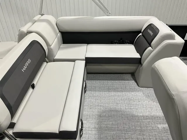 Slide: The Image of 2025 Harris Cruiser 210 SL boat interior with plush seating and modern design. - 8