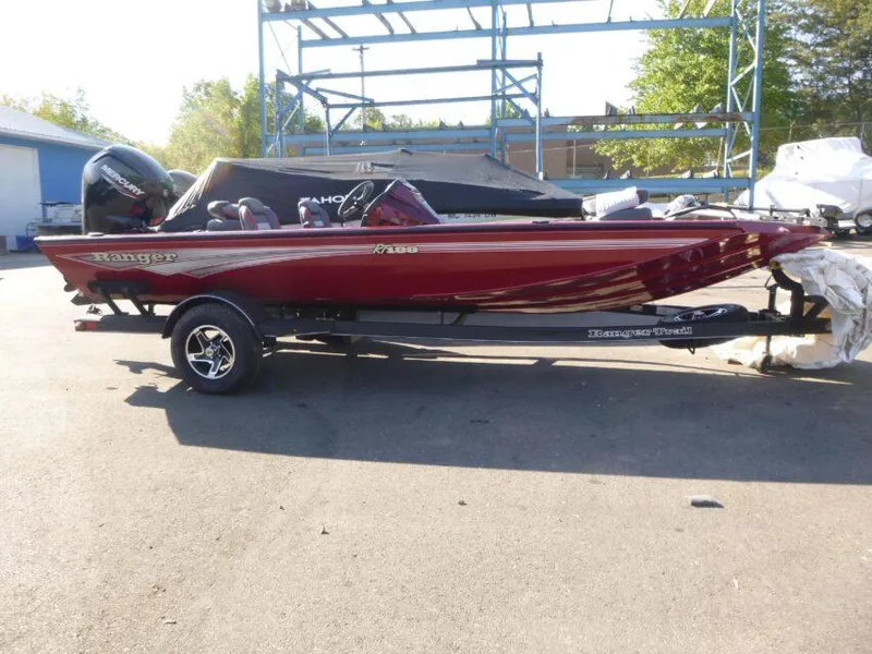 The Image of 2024 Ranger RT188 boat in red, parked outdoors on a trailer. - 0