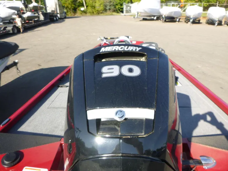 Slide: The Image of 2024 Ranger RT188 boat with Mercury 90 engine, parked outdoors. - 2