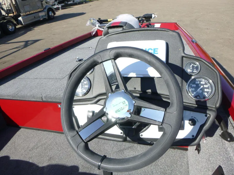 Slide: The Image of 2024 Ranger RT188 boat dashboard with steering wheel and gauges, featuring a red and gray interior. - 6