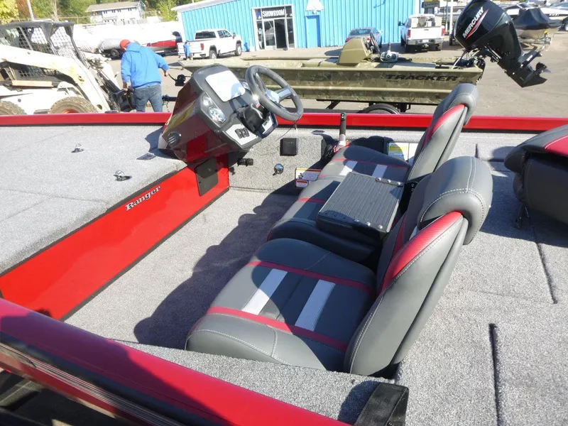 Slide: The Image of 2024 Ranger RT188 boat interior with red and gray seating, steering console, and carpeted flooring. - 8