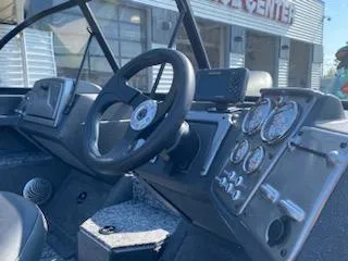 Slide: The Image of 2025 Tracker Pro Guide V-175 Combo boat dashboard with steering wheel and gauges. - 13
