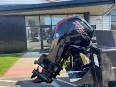 Slide: The Image of 2025 Tracker Pro Guide V-175 Combo boat engine outside a building. - 16
