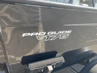 Slide: The Image of 2025 Tracker Pro Guide V-175 Combo boat side view with logo. - 17