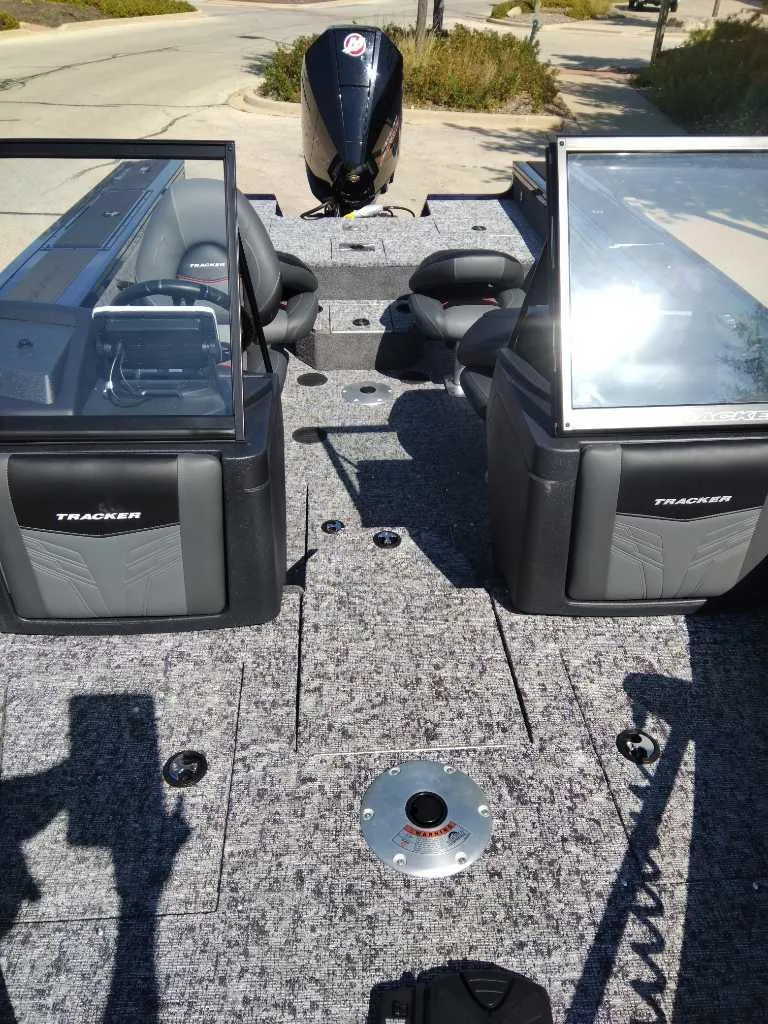 Slide: The Image of 2025 Tracker Targa V-18 WT boat interior with seating and console view. - 2