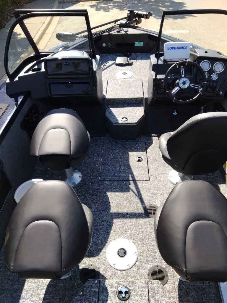 Slide: The Image of 2025 Tracker Targa V-18 WT boat interior with four seats and modern dashboard. - 3