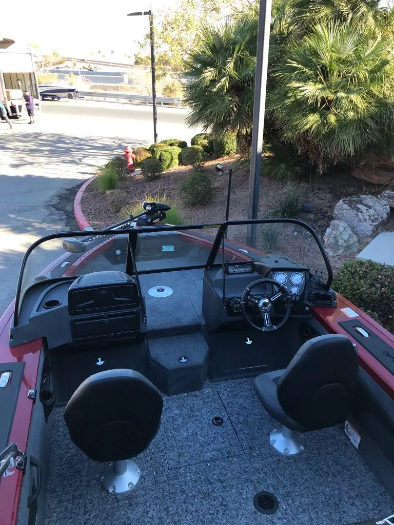 Slide: The Image of 2025 Tracker Targa V-18 Combo boat interior with dual seats and steering console. - 10