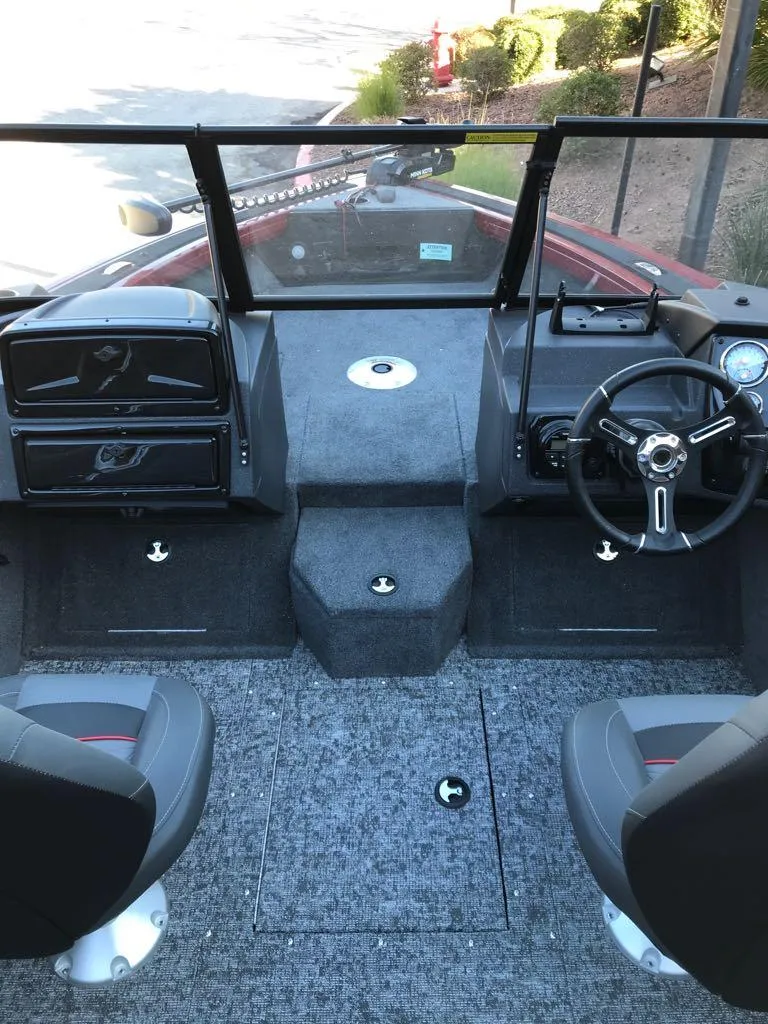 Slide: The Image of 2025 Tracker Targa V-18 Combo boat interior with dual seats and steering console. - 13