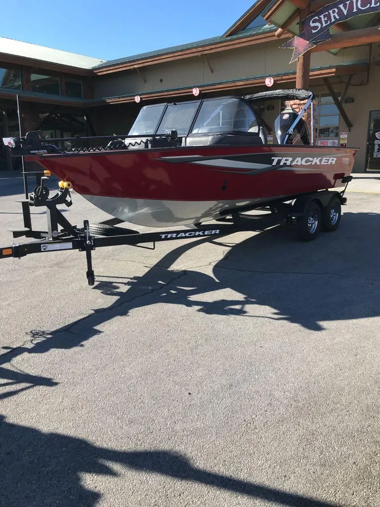Slide: The Image of 2025 Tracker Targa V-18 Combo boat on trailer, parked outdoors. - 2