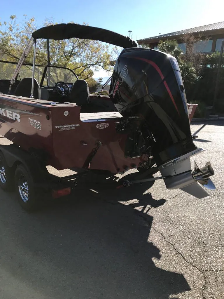 Slide: The Image of 2025 Tracker Targa V-18 Combo boat with powerful outboard motor in sunlight. - 4