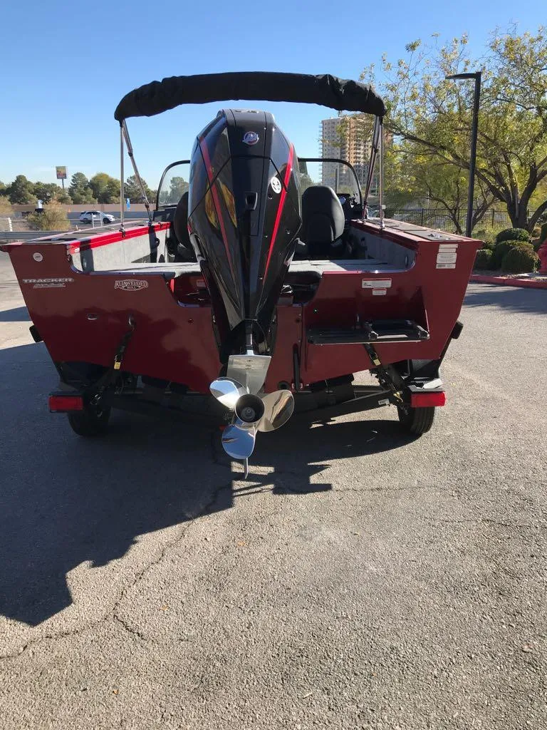 Slide: The Image of 2025 Tracker Targa V-18 Combo boat, rear view, parked outdoors. - 5