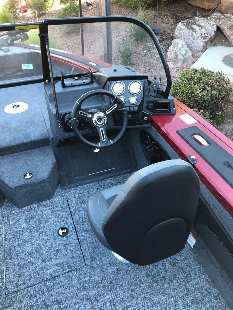 Slide: The Image of 2025 Tracker Targa V-18 Combo boat interior with steering wheel and seating. - 7