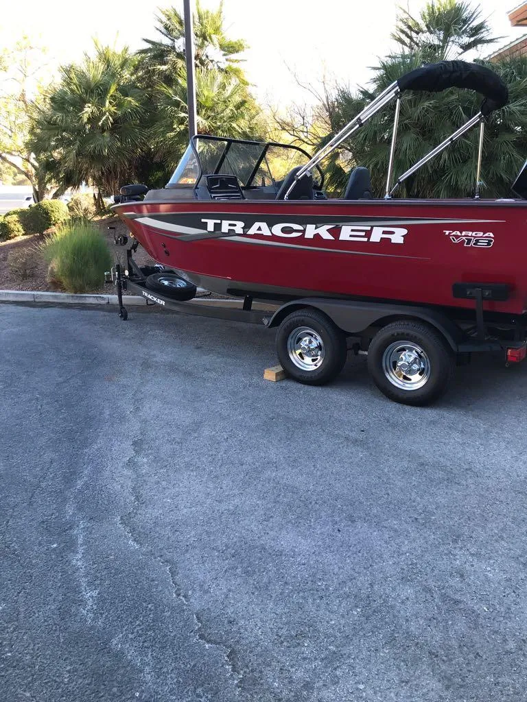 Slide: The Image of 2025 Tracker Targa V-18 Combo boat on trailer, parked outdoors. - 8