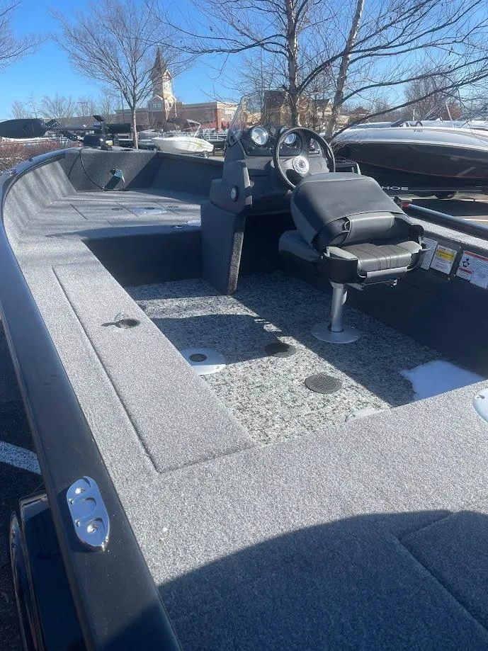 Slide: The Image of 2025 Tracker Super Guide V-16 SC fishing boat with spacious seating and modern dashboard. - 2