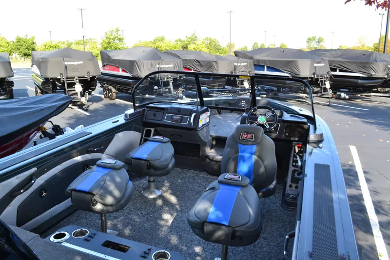 Slide: The Image of 2024 Ranger VX1988 WT boat interior with seating and dashboard, parked outdoors. - 2
