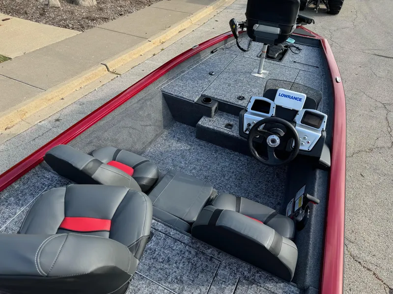 Slide: The Image of 2025 Tracker Pro Team 175 boat interior with steering wheel and seats, featuring Lowrance electronics. - 2