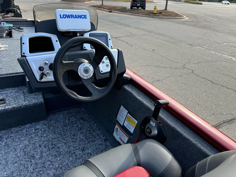Slide: The Image of 2025 Tracker Pro Team 175 boat dashboard with Lowrance electronics in a parking lot. - 3