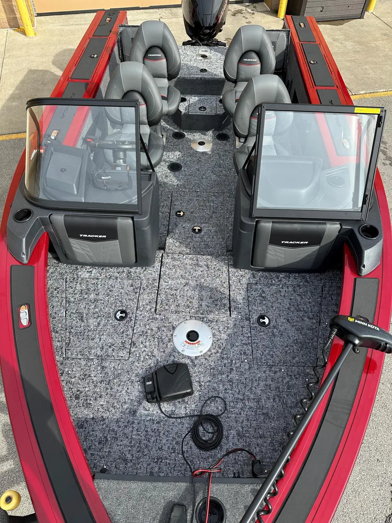 Slide: The Image of 2025 Tracker Targa V-18 Combo boat with dual windshields and seating, featuring a red and gray design. - 4