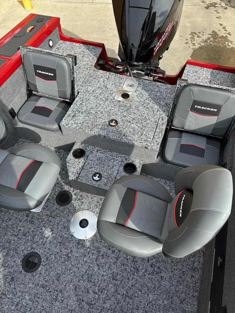 Slide: The Image of 2025 Tracker Targa V-18 Combo boat interior with gray seating and red accents. - 5