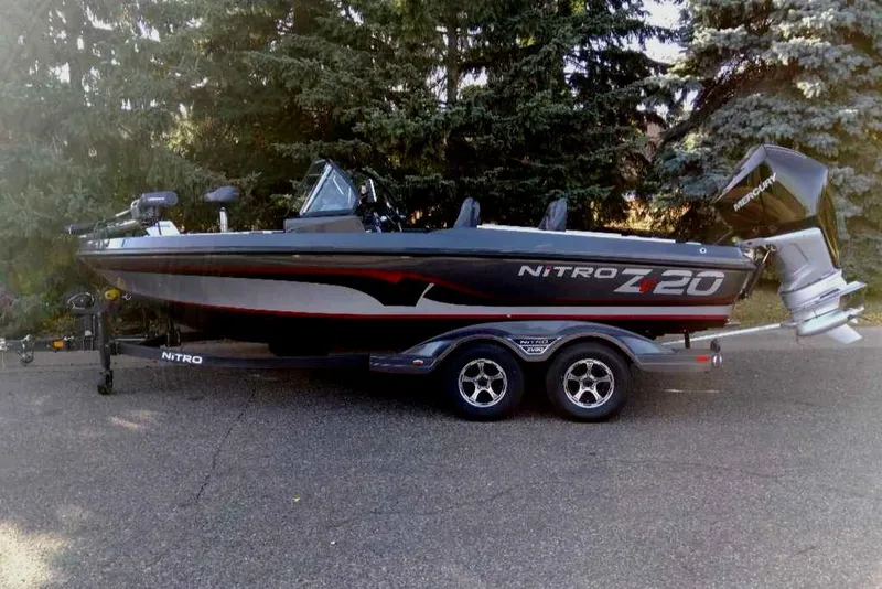 Slide: The Image of 2024 Nitro ZV20 Pro fishing boat on trailer, parked outdoors. - 13