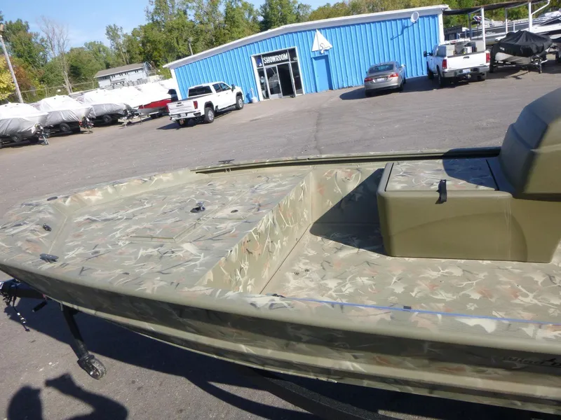Slide: The Image of 2024 Tracker Grizzly 1648 SC boat in a dealership parking lot. - 15