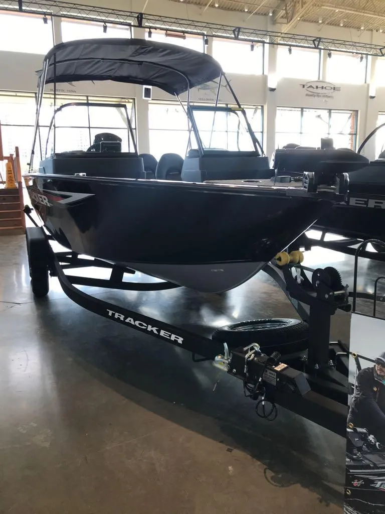Slide: The Image of 2025 Tracker Pro Guide V-175 WT boat on display in showroom. - 2