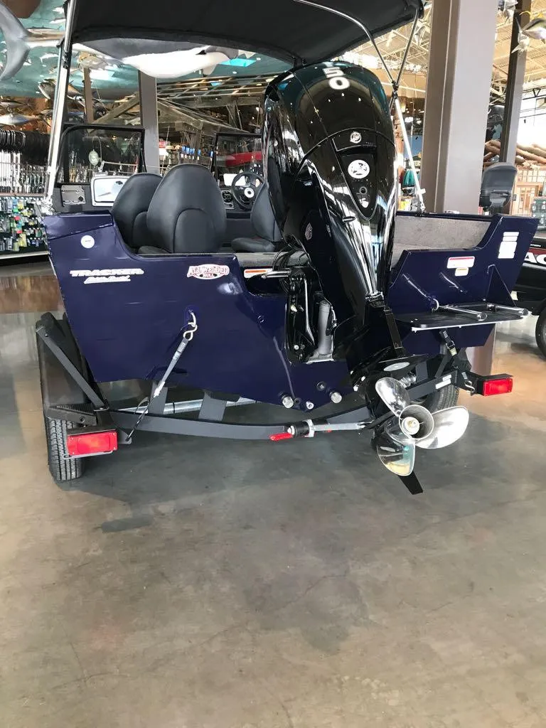 Slide: The Image of 2025 Tracker Pro Guide V-175 WT boat with outboard motor in showroom. - 3