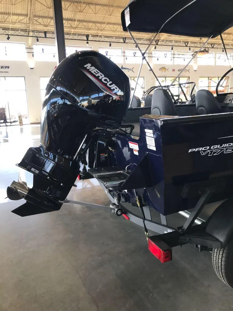 Slide: The Image of 2025 Tracker Pro Guide V-175 WT boat with Mercury outboard motor in showroom. - 4