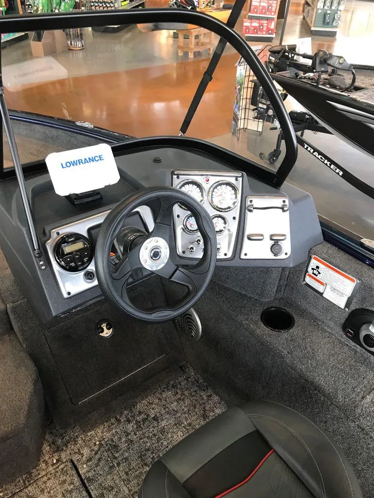 Slide: The Image of 2025 Tracker Pro Guide V-175 WT boat dashboard with steering wheel and gauges. - 6