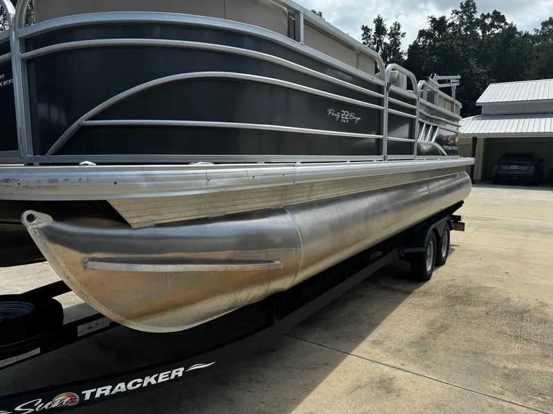 Slide: The Image of 2023 Sun Tracker Party Barge 22 DLX pontoon boat on trailer in driveway. - 13