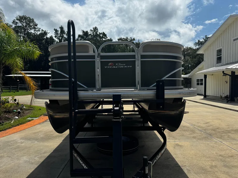 Slide: The Image of 2023 Sun Tracker Party Barge 22 DLX on trailer, parked in driveway. - 16