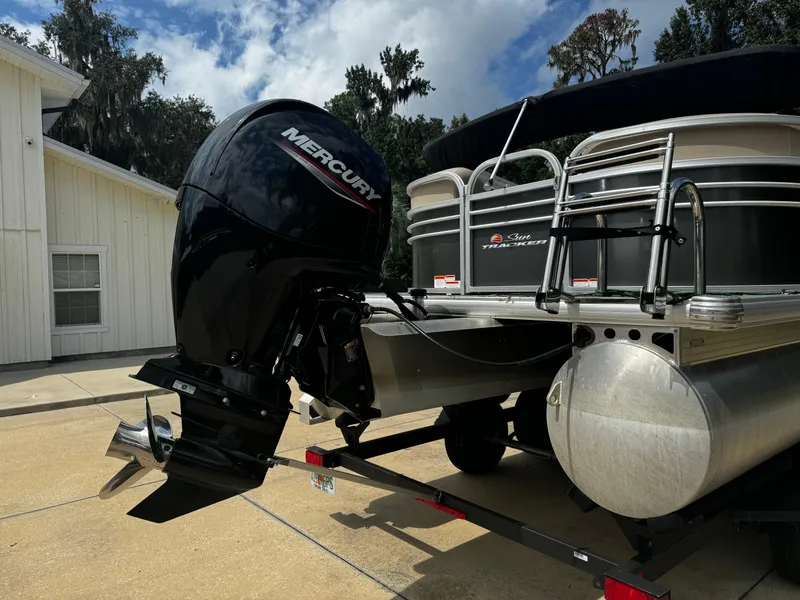Slide: The Image of 2023 Sun Tracker Party Barge 22 DLX with Mercury outboard motor on trailer. - 22