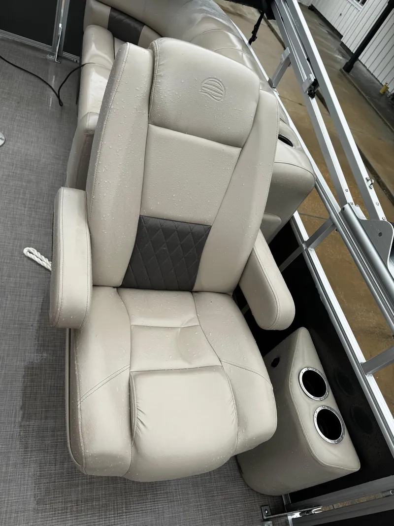 Slide: The Image of 2023 Sun Tracker Party Barge 22 DLX boat seat with cup holders, beige upholstery. - 23