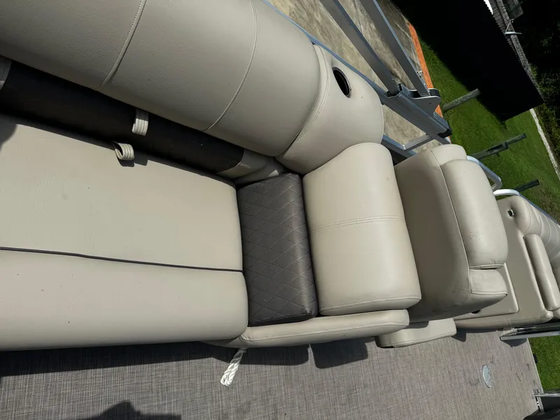 Slide: The Image of 2023 Sun Tracker Party Barge 22 DLX, beige seating, outdoor setting. - 32
