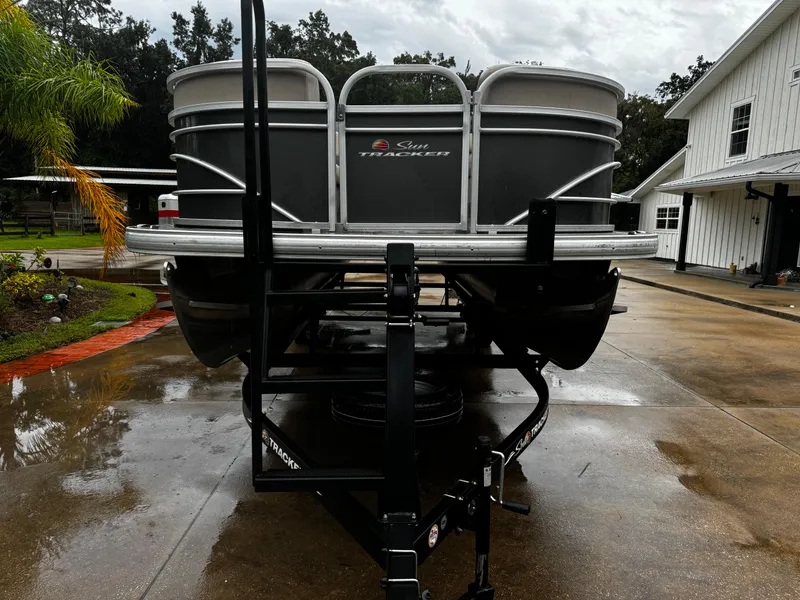 Slide: The Image of 2023 Sun Tracker Party Barge 22 DLX on trailer in driveway. - 5