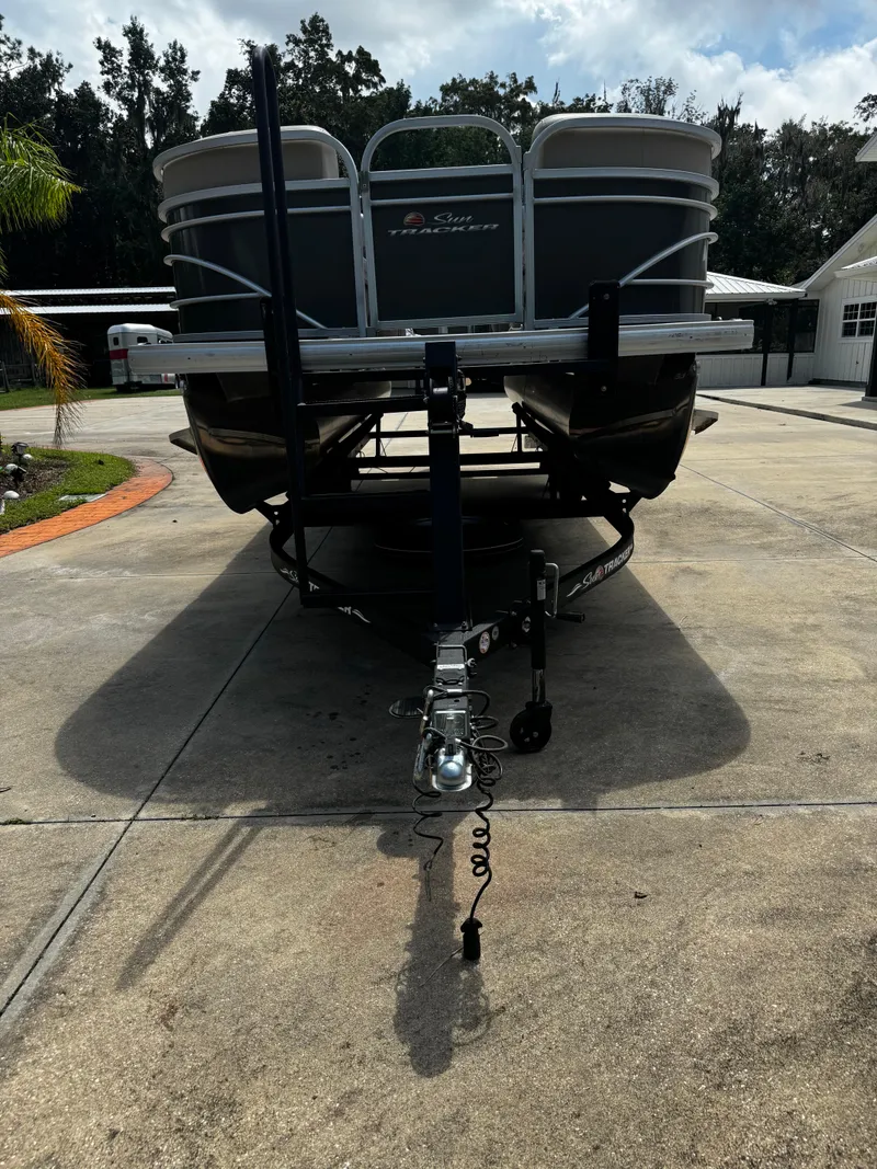 Slide: The Image of 2023 Sun Tracker Party Barge 22 DLX pontoon boat on a driveway. - 6