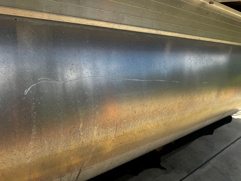 Slide: The Image of Close-up of 2023 Sun Tracker Party Barge 22 DLX pontoon with visible scratches. - 9